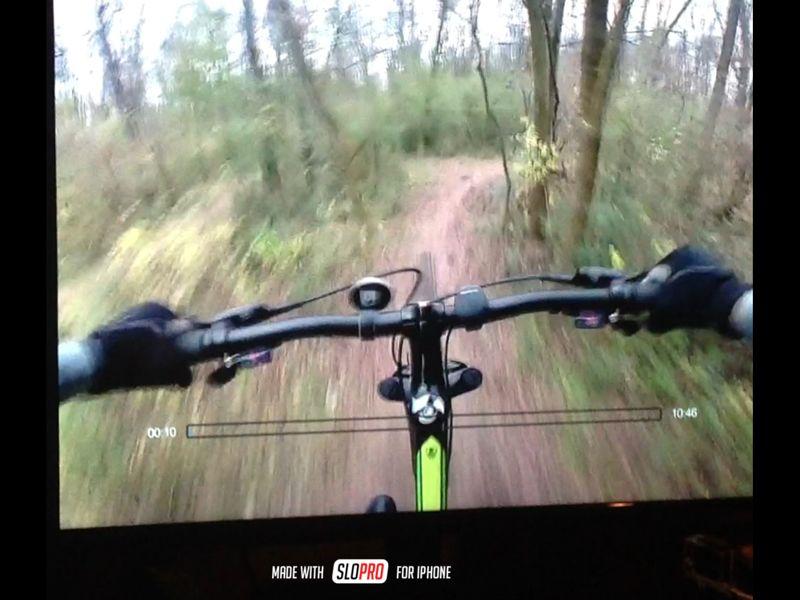 Alt text: A first-person view of bicycle handlebars navigating a dirt trail surrounded by trees and vegetation, indicating an outdoor mountain biking experience. A timestamp and video progress bar are visible at the bottom of the screen. Wessington Warrior Trail mountain bike trail.