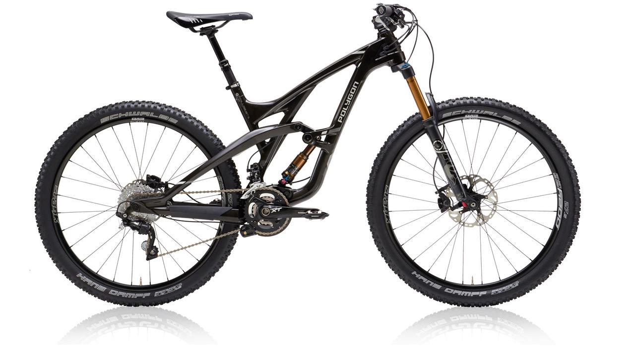 Polygon Collosus T8: A modern mountain bike with a sleek black frame, front suspension fork, rugged tires, and disc brakes, positioned on a reflective surface.