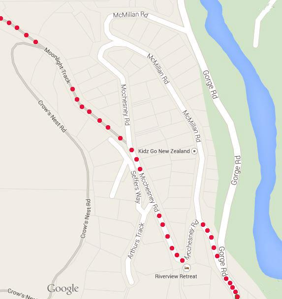 Map showing a residential area with labeled roads including McMillan Road, Gorge Road, and Mochnesey Road, with highlighted pathways and proximity to a river. The map also features a marker for "Kidz Go New Zealand" and indicates "Riverview Retreat." Moonlight Circuit mountain bike trail.