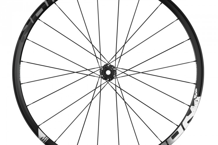 A black bicycle wheel featuring a sleek rim design with spokes radiating from the hub. The rim displays white graphics and markings. The image showcases the wheel from a frontal perspective against a white background.