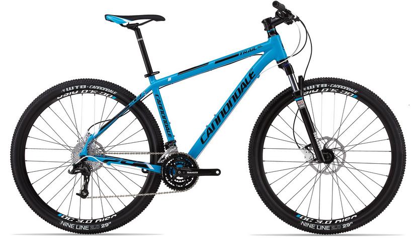 Cannondale Trail SL 29 2: Mountain bike with a blue frame, featuring a Cannondale logo. The bike has thick tires suitable for rough terrain, a front suspension fork, and a range of gears for versatile riding options. It is designed for off-road cycling.