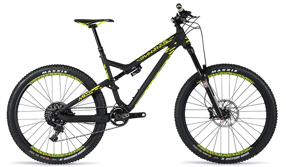 Commencal Meta AM V4: Alt text: A black mountain bike with bright yellow accents, featuring wide tires and a rear shock absorber. The bike is positioned to show its side profile, highlighting its sturdy frame and gear components.