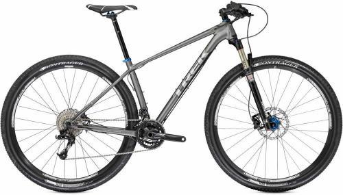 Trek Superfly 6: A gray Trek mountain bike with a lightweight frame, front suspension, and knobby tires, designed for off-road cycling. The bike features a sleek design, with a black saddle and blue accents on the frame.