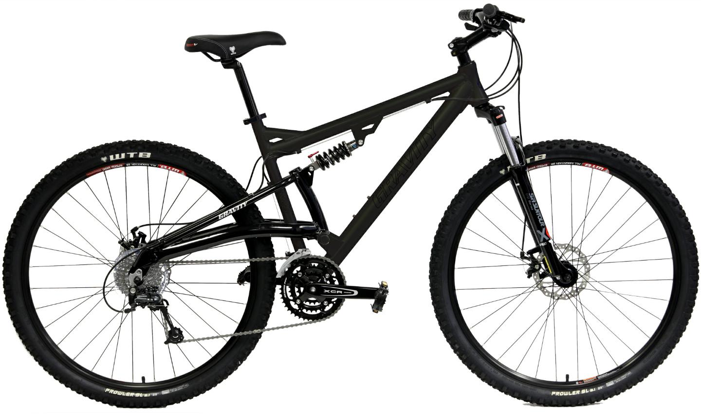 Gravity FSX 29One: A black mountain bike with a sleek frame, featuring front and rear suspension, wide tires, and a modern design for off-road cycling. The bike is equipped with various gears and disc brakes, highlighting its suitability for rugged terrains.