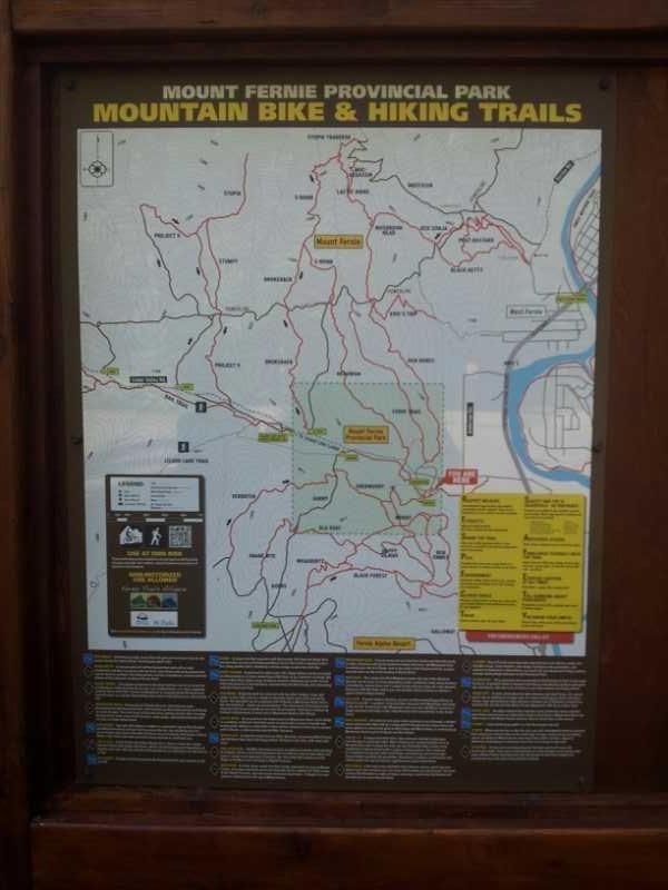 Map of Mount Fernie Provincial Park showcasing mountain bike and hiking trails. The map includes various trails marked in red and green, key locations such as Mount Fernie, and information on trail conditions and safety guidelines. Additionally, there are icons indicating different activities and features in the park. Mount Fernie Provincial Park mountain bike trail.