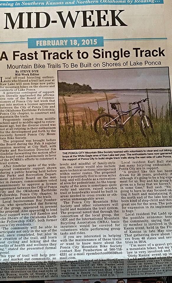 Gary Fisher Sugar 4: A newspaper article titled "A Fast Track to Single Track," published on February 18, 2015, discusses plans for building mountain bike trails along the shores of Lake Ponca. The article includes a photograph of a mountain bike positioned on a sandy path near the water. It highlights community support for the project, led by the Ponca City Mountain Bike Society, and mentions local officials' endorsement of the initiative to enhance recreational opportunities in the area.