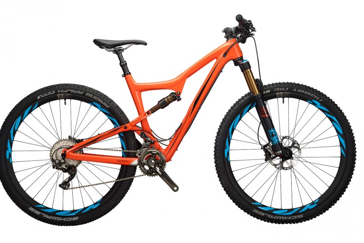 A bright orange mountain bike with blue accents, featuring a full suspension frame, wide tires, and disc brakes. The bike is shown from the side, highlighting its sleek design and components.