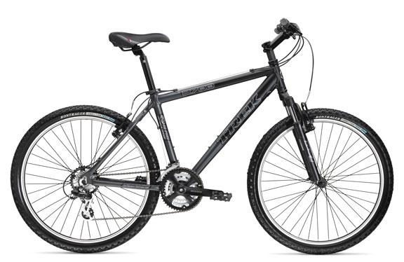 Trek 3700: A black and gray mountain bike with a lightweight frame, featuring thick tires and a suspension system. The bike has a comfortable saddle, adjustable handlebars, and multiple gears, suitable for off-road riding.