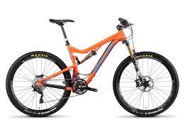 Santa Cruz 5010: A vibrant orange mountain bike with a durable frame, disc brakes, and wide tires designed for off-road terrain. The bike features a suspension system for enhanced comfort and performance on rugged trails.