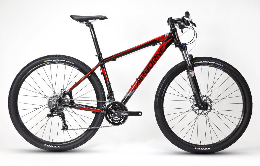 Airborne Guardian: Alt text: A black and red mountain bike with a lightweight frame, equipped with disc brakes and rugged tires, positioned against a white background.