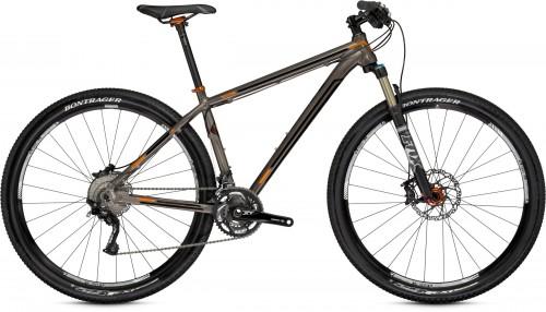 Trek Superfly AL Elite: A mountain bike featuring a sleek gray and orange frame, equipped with front suspension, disc brakes, and durable tires designed for off-road terrain. The bike is depicted against a neutral background.