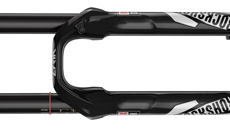 Black mountain bike suspension fork with adjustable settings and branding visible on the sides. The fork features a glossy finish and is shown from a top-down perspective, highlighting its structural design and functionality.