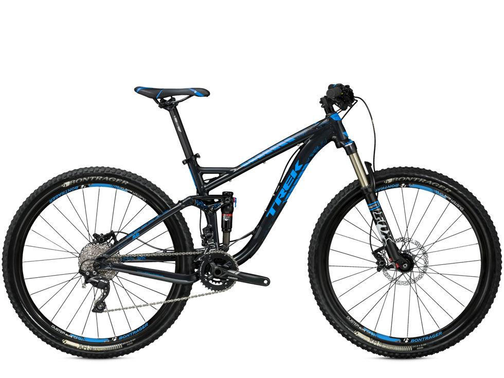 Trek Fuel EX 7: A black and blue Trek mountain bike with a lightweight frame, equipped with wide tires and disc brakes, positioned on a white background. The bike features a prominent suspension system for off-road capabilities and has a modern design suitable for trail riding.