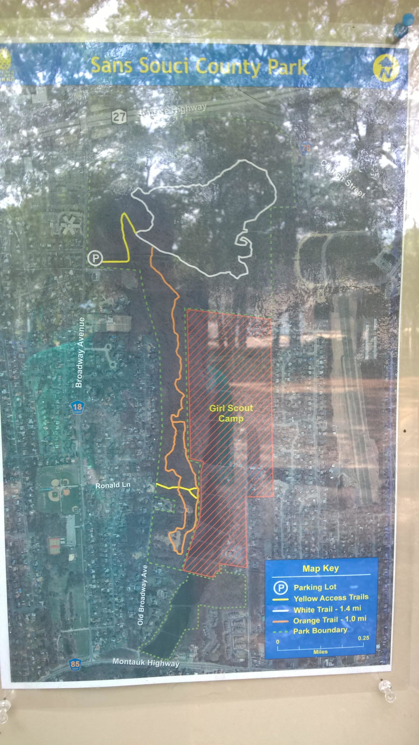Map of Sans Souci County Park, displaying trails and facilities, including access trails, a parking lot, and the boundary of the park. The map highlights a designated area for Girl Scout Camp and indicates different trail lengths, marked in various colors for easy navigation. Sans Souci Preserve mountain bike trail.