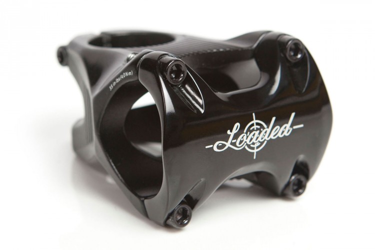 Black bicycle stem with a sleek design and white "Loaded" branding, featuring multiple bolts and a textured grip area.