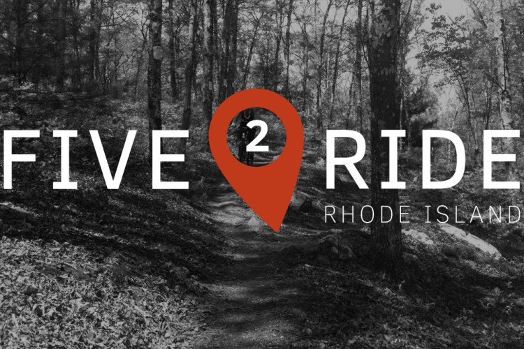 A wooded path in a forest, overlaid with the text "FIVE 2 RIDE RHODE ISLAND" in bold letters, featuring a location pin graphic around the number "2." The image has a black-and-white filter with natural elements visible in the background.