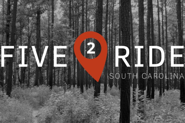 Image of a forest scene in black and white, featuring tall trees and greenery. Overlaid with the text "FIVE 2 RIDE" in large white letters and "SOUTH CAROLINA" in smaller font, accompanied by a red location pin shape around the number "2."