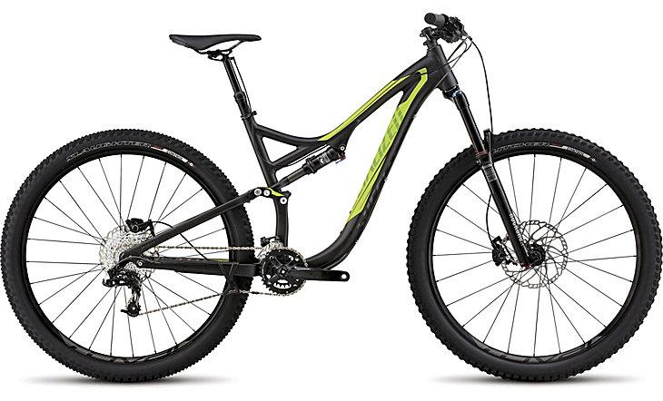 Specialized Stumpjumper FSR Comp EVO: A modern mountain bike featuring a sleek black frame with vibrant green accents. It has thick, knobby tires designed for off-road trails, a suspension system for shock absorption, and a geared drivetrain for versatile terrain navigation. The bike is positioned against a neutral background, highlighting its design and features.