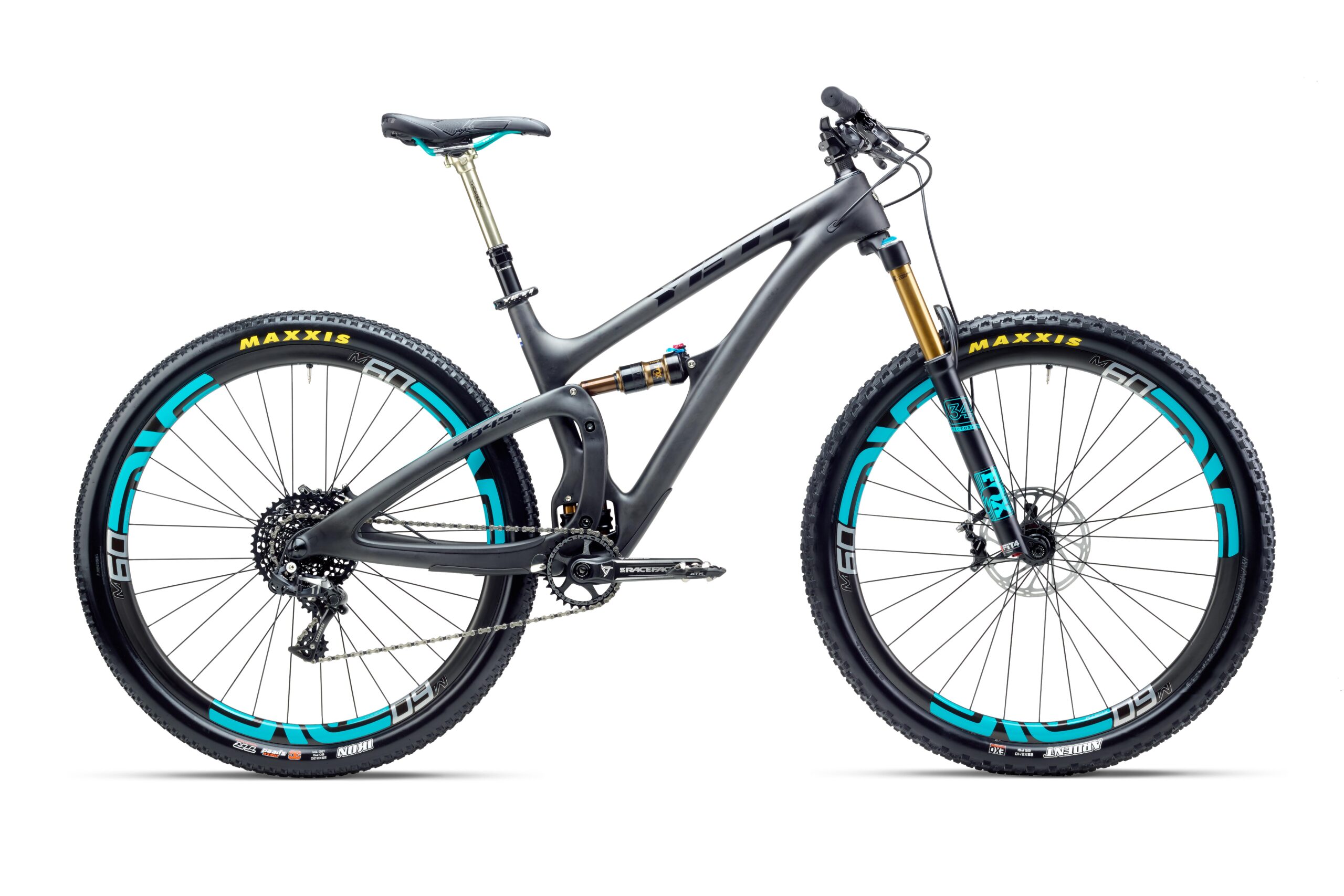 Yeti SB4.5c: A modern mountain bike with a sleek gray frame, featuring turquoise accents on the wheels and seat. It has high-performance components, including front suspension forks and thick tires designed for rugged terrain. The bike's drivetrain is visible, showcasing the gears and chain, and it stands on a clean, white background.