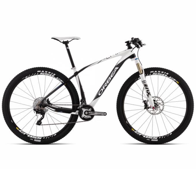 Orbea Alma M30: Alt text: A white Orbea mountain bike with black and silver accents, featuring a lightweight frame, front suspension fork, and disc brakes. The bike is positioned to showcase its design, with Maxxis tires visible on both wheels.