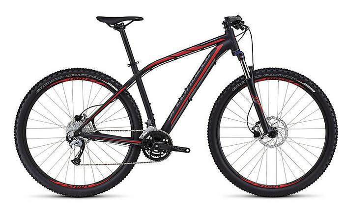Specialized Rockhopper 29: Black and red mountain bike with a lightweight frame, front suspension, and distinct treaded tires, designed for off-road cycling.