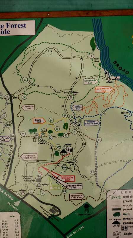 Map of a forest area, detailing various trails, points of interest, and features such as parking and picnic areas. The map includes a legend for trail types and major landmarks, with paths marked for hiking, biking, and other activities. Harbison State Forest mountain bike trail.