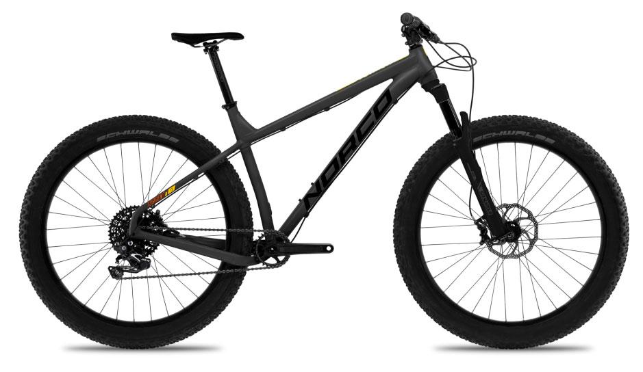 Norco Torrent 7: Alt text: A black mountain bike with thick tires and a sleek design, featuring a single gear and disc brakes, positioned at an angle to show the frame and wheels.