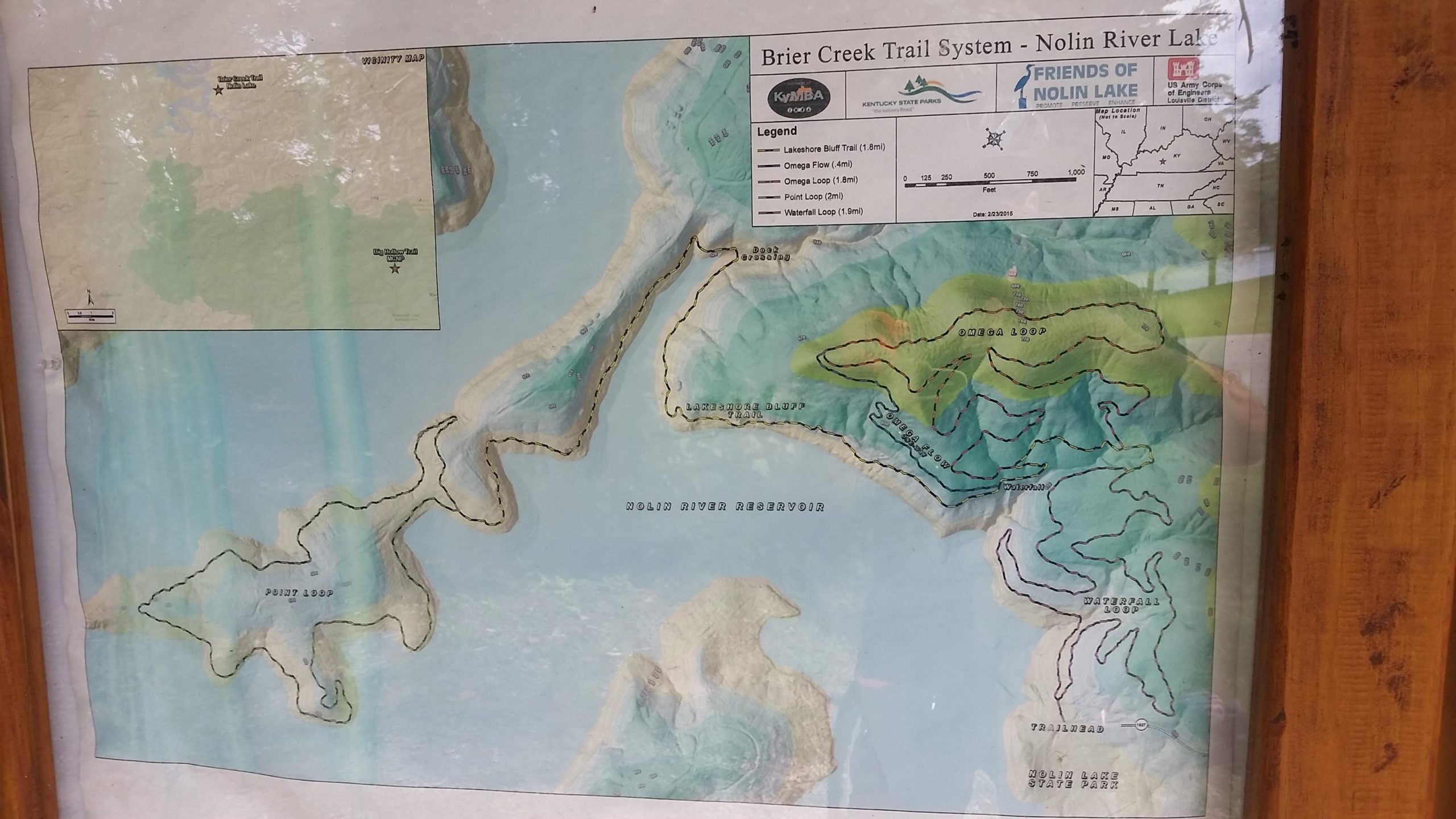 Map of the Brier Creek Trail System at Nolin River Lake, showing various trails including Lakeshore Bluff Trail, Omega Loop, Point Loop, and Waterfall Loop. The map features contour lines, a legend, and demonstrates the trail layout in relation to the surrounding terrain and waterways. Brier Creek mountain bike trail.