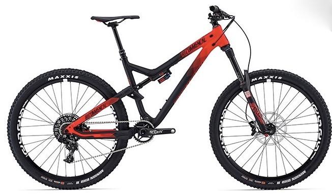 Commencal Meta AM V4: Mountain bike featuring a sleek design with a black and red color scheme, equipped with large tires and disc brakes, ideal for off-road trails and rough terrain. The bike showcases a sturdy frame and advanced suspension system.