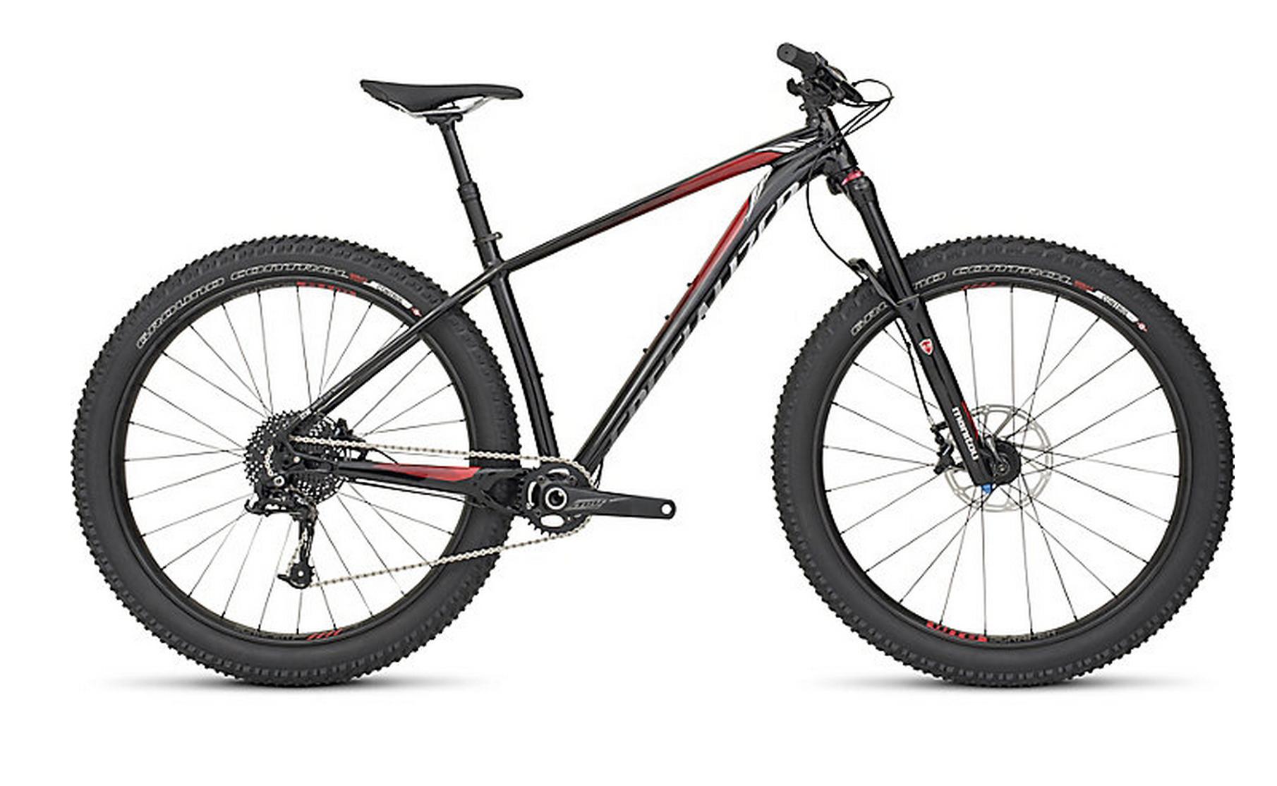 Specialized FUSE EXPERT 6FATTIE: A black and red mountain bike with wide tires, featuring a lightweight frame, front suspension, and a single chainring drivetrain. The bike is positioned at a slight angle, highlighting its sleek design and components.
