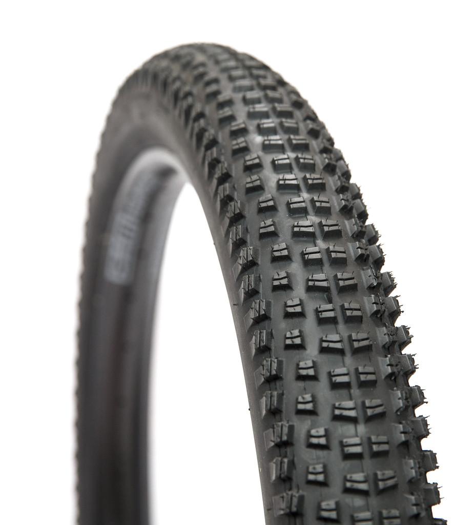 WTB Trail Boss: A close-up image of a black bicycle tire featuring a textured tread design, suitable for mountain or off-road cycling. The tire's surface displays a pattern of small, raised knobs for enhanced grip and traction.