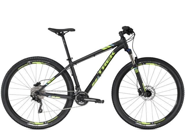 Trek X-Caliber: A black mountain bike with green and white accents, featuring a lightweight frame, front suspension fork, and knobby tires designed for off-road riding. The bike has a single gear shifter and disc brakes, showcasing a modern design suitable for trail riding and outdoor adventures.