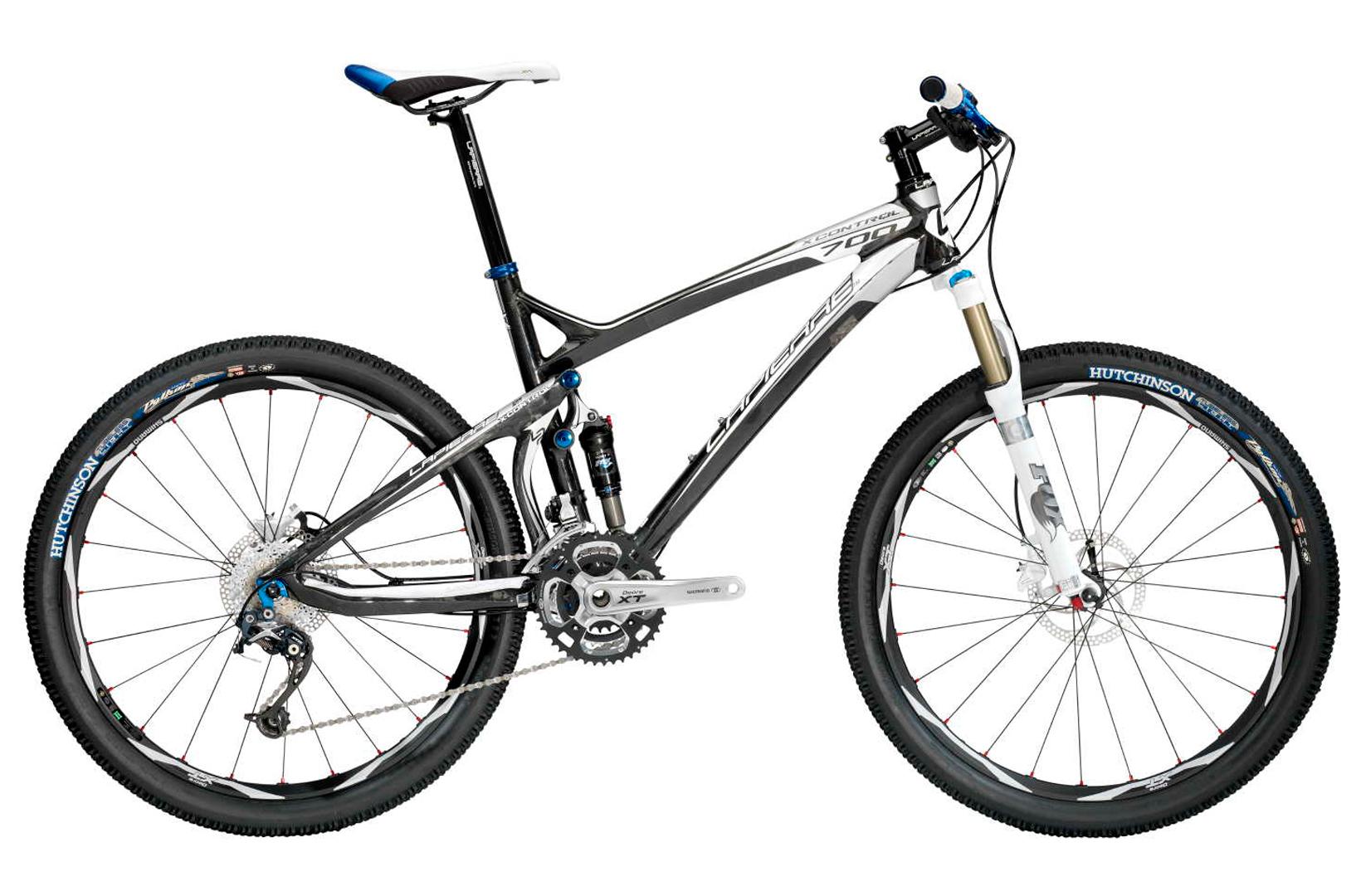 Lapierre Lapierre X-Control Race 700 (2010): A sleek black and white mountain bike with blue accents, featuring a lightweight frame, front suspension, and disc brakes. The bike is equipped with high-performance tires and a Shimano XT drivetrain, ideal for off-road cycling.