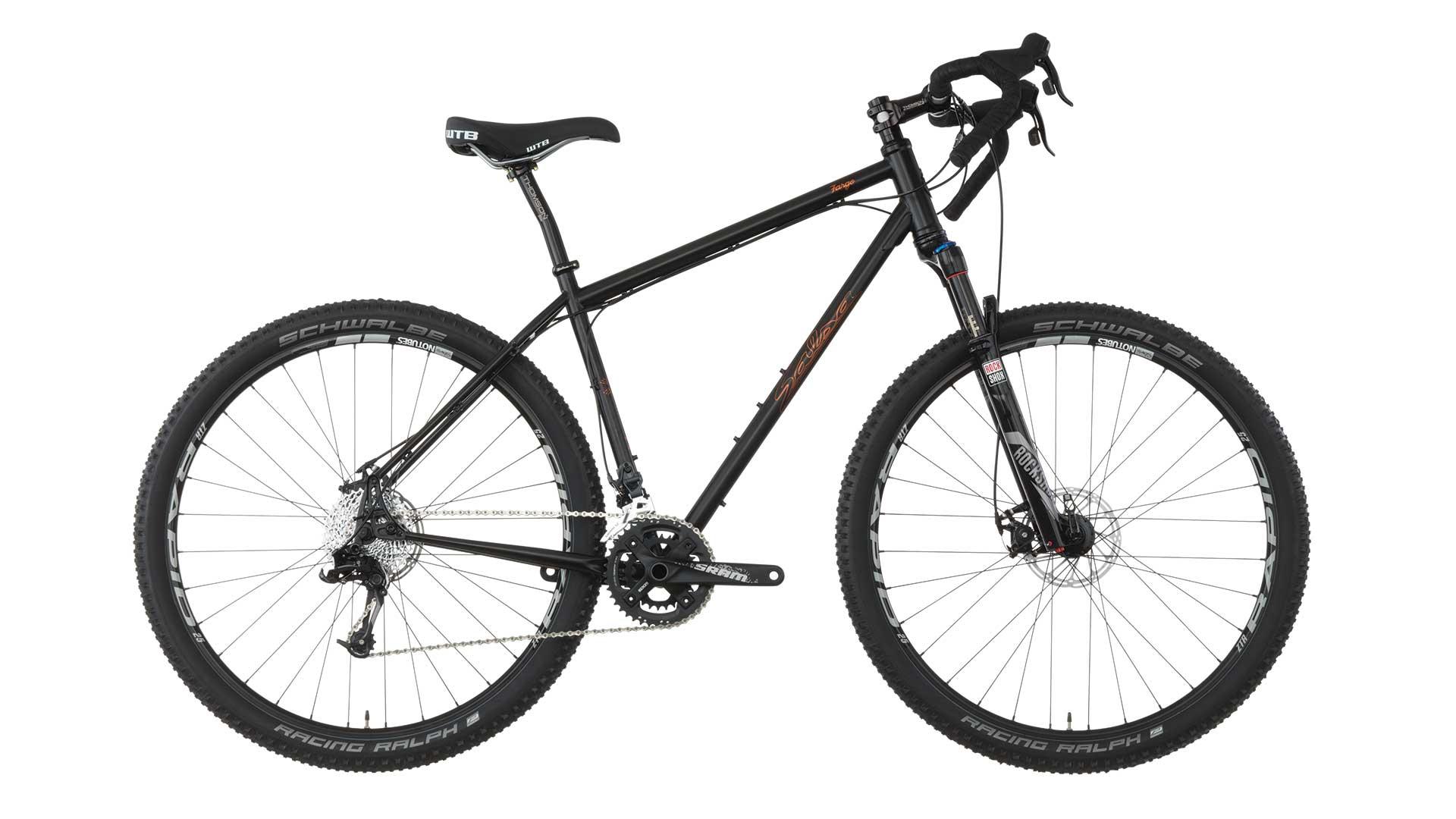 Salsa Fargo: A black mountain bike with wide tires and disc brakes, featuring a sleek frame design and a drop handlebar. The bike is shown from the side, highlighting its components, including the gear system and suspension fork.