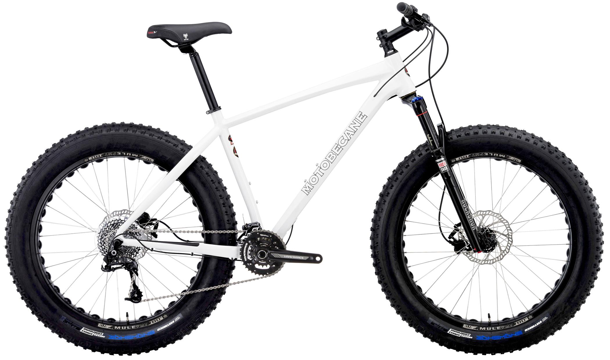 Motobecane Sturgis Bullet: A white fat tire mountain bike with wide, knobby tires, a black suspension fork, and a sleek design. The bike features a modern frame and a multi-speed rear cassette, ideal for rugged terrains.