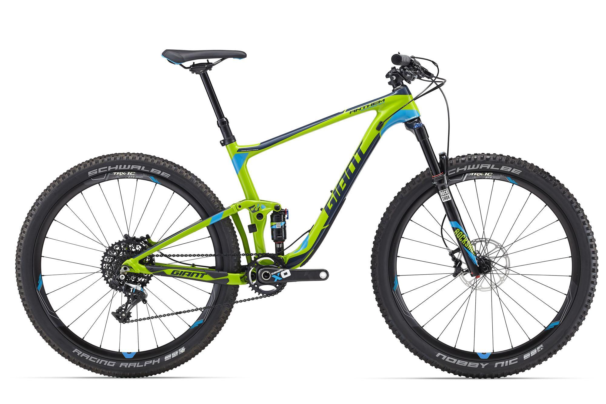 A vibrant green and blue mountain bike with a sleek design, featuring knobby tires and a rear suspension system. The bike is positioned upright against a white background, showcasing its high-performance components and racing features.