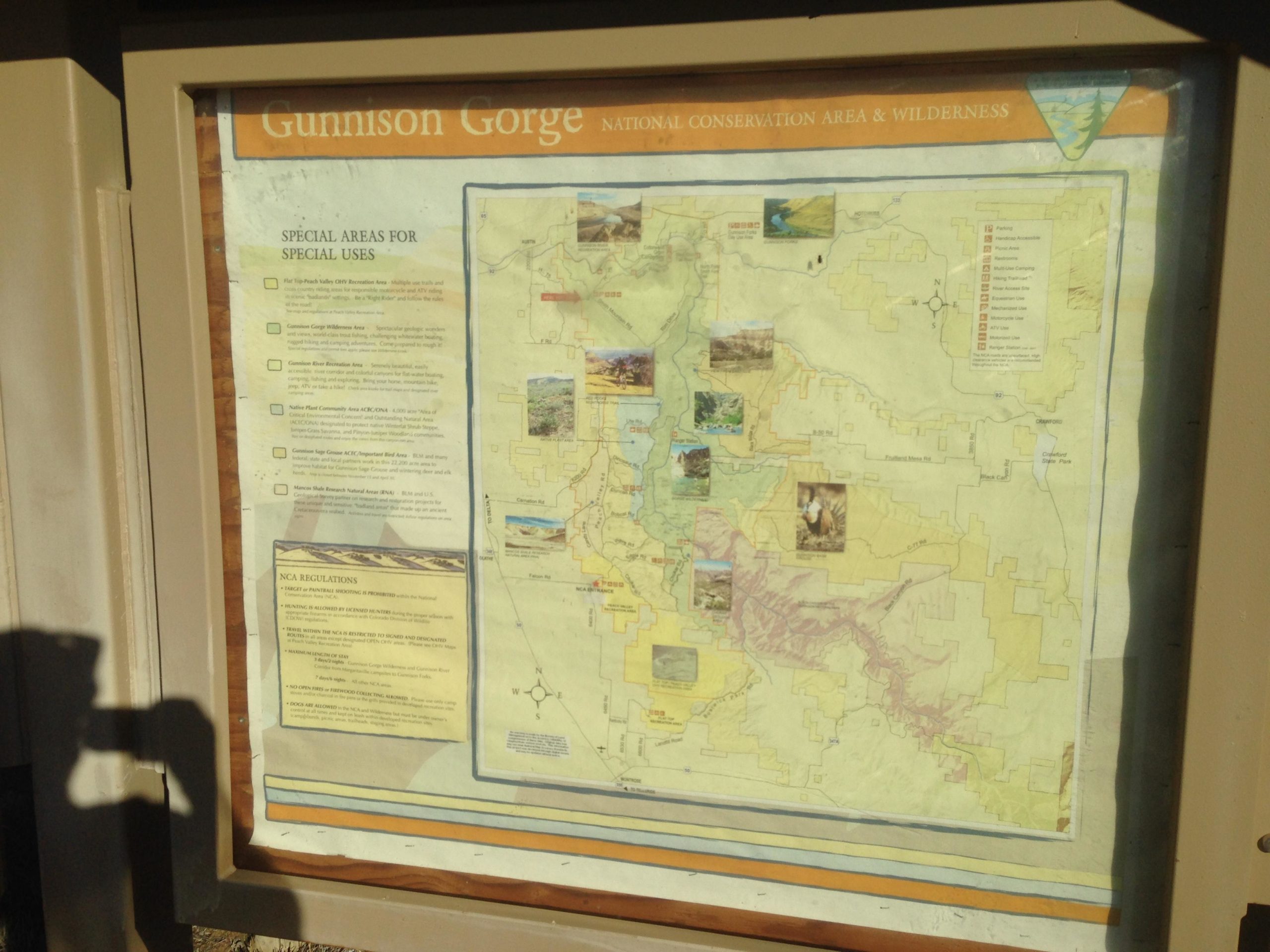 Map of Gunnison Gorge National Conservation Area and Wilderness, detailing special use areas, regulations, and notable features. The map includes various icons and images related to recreational activities and natural landmarks in the area. Sidewinder mountain bike trail.
