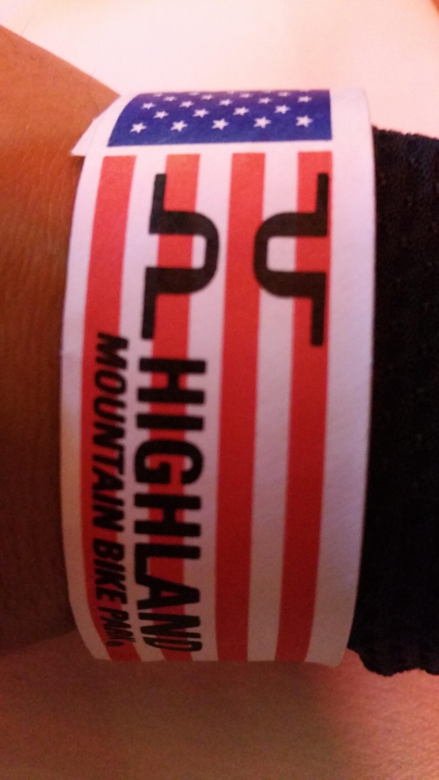 Trek Remedy 9: A wristband featuring a design with red and white stripes, a blue section with stars, and the text "HIGHLAND MOUNTAIN BIKE PARK."