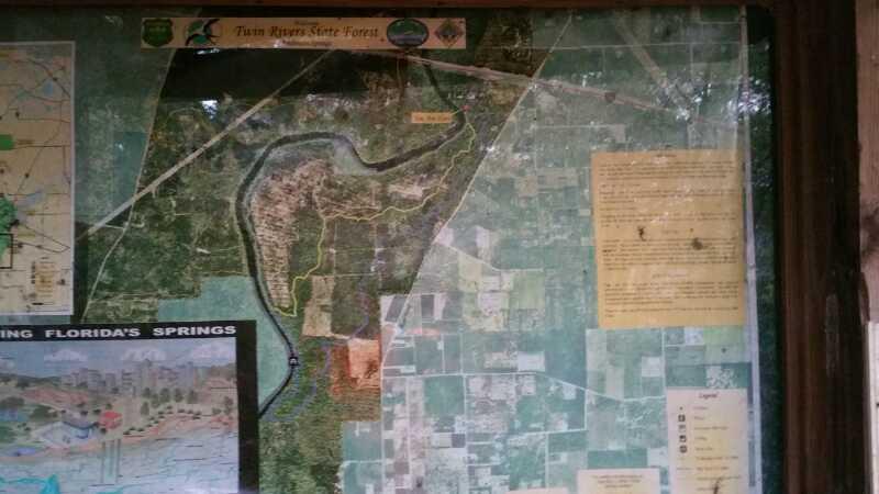 Map of Twin Rivers State Forest, displaying various trails and features. The image features an overview of the forest area, including roads, waterways, and surrounding landscape. Additional information is presented in text boxes, detailing points of interest and guidelines for visitors. Anderson Springs mountain bike trail.
