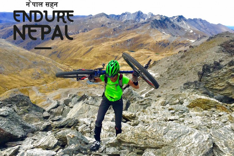 A mountain biker in a bright green shirt and helmet carries their bike up a rocky slope in a mountainous landscape, with rolling hills and peaks in the background. The image includes the text "ENDURE NEPAL" at the top.