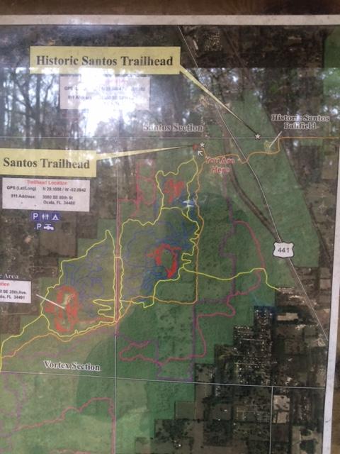 Map of the Historic Santos Trailhead displaying the layout of trails in the Santos section and Vortex section, with GPS coordinates and trailhead information. The map includes color-coded trail routes, parking areas, and nearby roads. Santos mountain bike trail.
