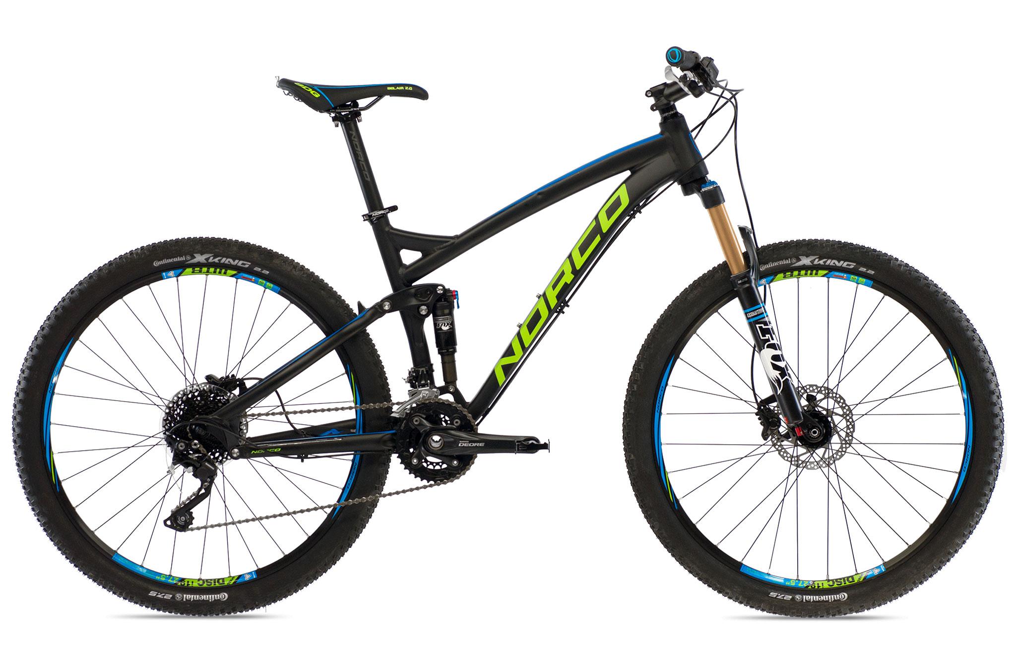Norco Fluid 7.1: A black and blue mountain bike with a vibrant green logo, featuring wide tires and a front suspension fork. The bike is positioned diagonally, showcasing its sleek frame, gear components, and disc brakes.