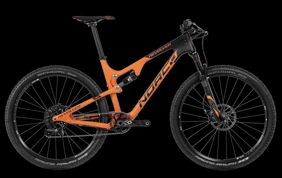 Norco Revolver 7 FS: Alt text: A black and orange Norco Revolver mountain bike, featuring a carbon frame and equipped with Schwalbe Racing Ralph tires and front suspension, displayed against a dark background.