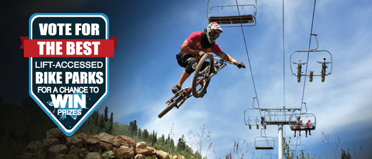 A mountain biker is performing a jump in mid-air against a backdrop of a ski lift and scenic greenery. The image includes a banner on the left that encourages viewers to vote for the best lift-accessed bike parks for a chance to win prizes.