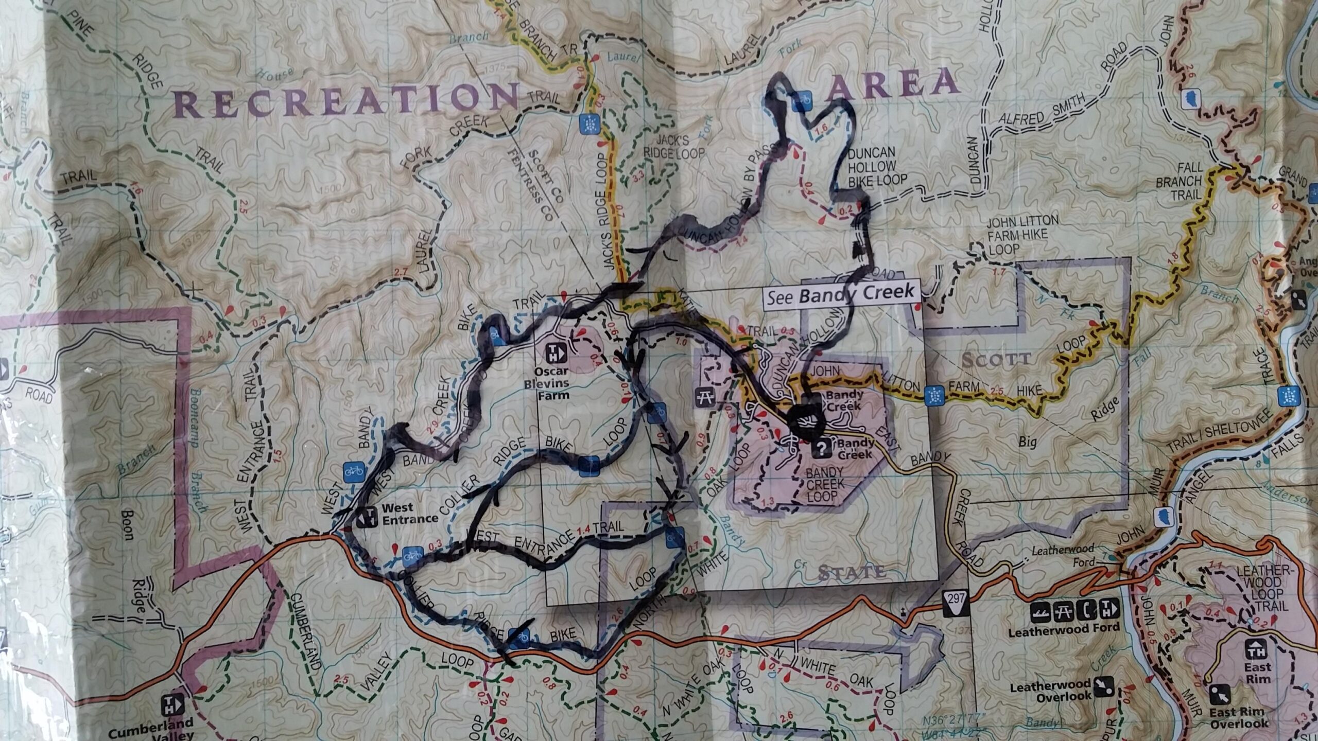 Map of a recreational area, featuring various trails, roads, and points of interest. The map shows detailed topography with marked hiking and biking paths, including notable locations such as Bandy Creek and Oscar Blevins Farm. Big South Fork mountain bike trail.