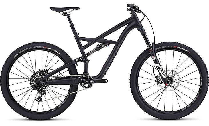 Specialized Enduro Comp 650b: A sleek black mountain bike with a modern frame design, featuring front and rear suspension, wide tires, and disc brakes. The bike is positioned on a white background, showcasing its geometric lines and components.