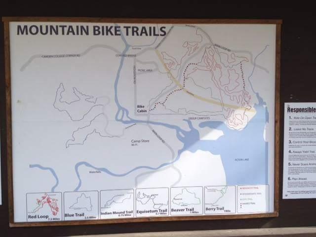 Map displaying mountain bike trails, including highlighted routes such as the Red Loop, Blue Trail, Indian Mound Trail, Equisetum Trail, Beaver Trail, and Berry Trail. The map also indicates locations like the Bike Cabin and nearby campgrounds near a body of water. A list of responsible riding guidelines is provided on the right side of the map. Hueston Woods State Park mountain bike trail.