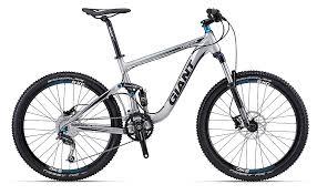 Giant Trance X4: A silver and black mountain bike featuring a lightweight frame, disc brakes, and thick tires, designed for rugged terrain.