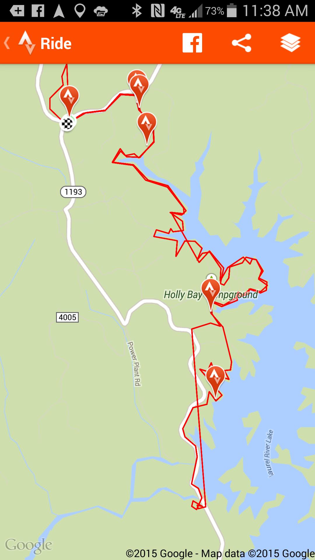 Map showing a red marked trail along with several location icons in the vicinity of Holly Bay Campground, near Laurel River Lake. The map features surrounding roads and points of interest, indicating a recreational route for cycling or hiking. Sheltowee Trace - Laurel Lake Trail mountain bike trail.