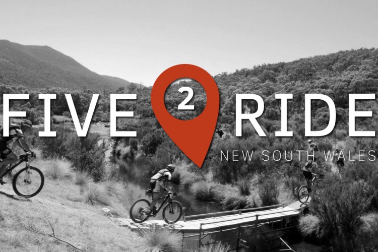 Alt text: A black and white image featuring mountain bikers riding through a scenic landscape in New South Wales, with the text overlay "FIVE 2 RIDE" and a location pin icon.